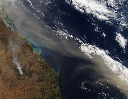 Drought is a frequent visitor in Australia. The Australian Bureau of Meteorology describes the typical rainfall over much of the continent as "not only low, but highly erratic." As 2009 drew to a close, the southeastern states of Victoria and New South Wales were enduring their third year of drought, which has been devastating for farmers. 
Dry, windy weather sent clouds of dust across Northern Queensland toward New Zealand on September 24, 2009. The tan dust is densely concentrated in a compact plume along the coastline, and can be seen mingling with gray smoke from wildfires in the middle-left of the image. Dry conditions kill off vegetation that normally anchors soil in place, helping create the conditions that lead to dust storms. Climate models predict agricultural and forest production will decline over much of southern and eastern Australia, and over parts of eastern New Zealand, due to increased drought and fire.

Image taken by the Moderate Resolution Imaging Spectroradiometer (MODIS) onboard NASA's Terra satellite on September 24, 2009.
Courtesy Jeff Schmaltz, MODIS Rapid Response Team, NASA GSFC.