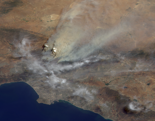 A fiery combination of heat, drought and a multi-year accumulation of dense, dry underbrush all contributed to the rapid spread of the arson-caused Station Fire, the largest fire in Los Angeles County's modern history. On August 26, 2009, the Multi-angle Imaging Spectroradiometer (MISR) instrument onboard NASA's Terra satellite captured this image, along with 3D information about the fire's smoke plume, which climbed more than 7 kilometers (4.3 miles) up into the atmosphere.  The wind is blowing from the lower left toward the upper right in this image, and in addition to the whitish-brown smoke, a band of gray-white cloud appears to bend around the heat island caused by the fire.  

Wildfire activity in the western U.S. has increased markedly since the mid-1980s, with more frequent large fires and longer fire seasons. Climate models predict increased wildfire risk across many areas of the globe in coming decades.

Image taken by the Multi-angle Imaging SpectroRadiometer (MISR) instrument on NASA's Terra satellite on August 30, 2009.
Credit: NASA/GSFC/LaRC/JPL, MISR Team.