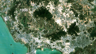 link to multimedia item number 1057 entitled 'Shenzhen, China Land Use - True Color 1988 to 1996 (With Dates)'. Description is 'True color Landsat image with date, Shenzhen, China, 1996.'