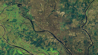 link to multimedia item number 2323 entitled 'Dhaka, Bangladesh Urban Growth'. Description is 'Dhaka, Bangladesh on 1-29-2001 taken by Landsat-7-ETM+ showing further urban growth since 1989 (using bands 5, 4, 2).'