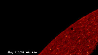 The dark spot is Mercury, just as it passes over the solar disk.