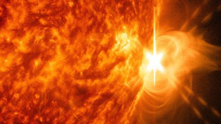 An X 1.4 solar flare erupted on the right side of the sun on the evening of April. 24, 2014. This composite image, captured at 8:42 p.m. EST, shows the sun in ultraviolet light with wavelength of both 131 and 304 angstroms.  Cropped.