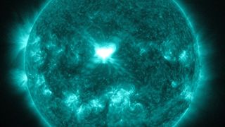 An X1.6 class solar flare flashes in the middle of the sun on Sept. 10, 2014. This image was captured by NASA's Solar Dynamics Observatory and shows light in the 131 angstrom wavelength, which is typically colorized in teal.  Credit: NASA/SDO