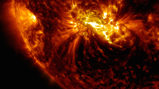 An active region on the sun erupted with a mid-level flare on Oct. 21, 2014, as seen in the bright light of this image captured by NASA's Solar Dynamics Observatory. This image shows extreme ultraviolet light that highlights the hot solar material in the sun's atmosphere.   Credit: NASA/GSFC/SDO