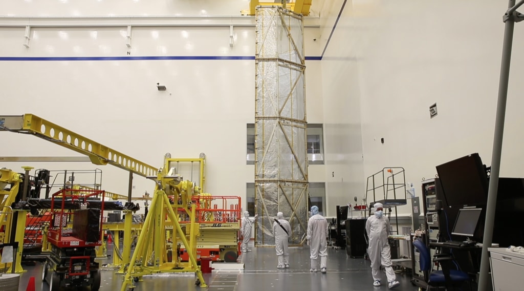 B-Roll footage of engineers at Northrop Grumman in Los Angeles California, covering the James Webb Space Telescope's Spacecraft Element with a tent cover before it was moved to the acoustic testing facility for testing.