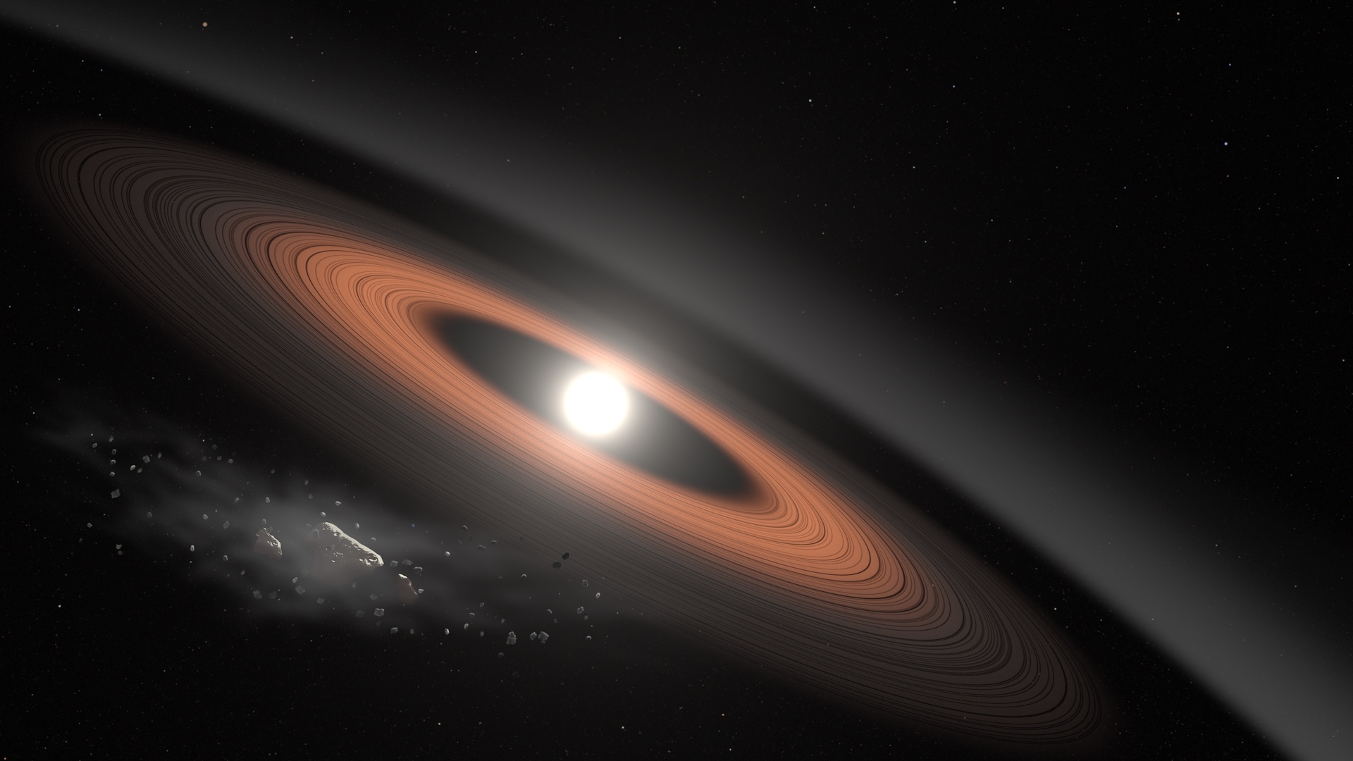 In this illustration, an asteroid (bottom left) breaks apart under the powerful gravity of LSPM J0207+3331, the oldest, coldest white dwarf known to be surrounded by a ring of dusty debris. Scientists think the system’s infrared signal is best explained by two distinct rings composed of dust supplied by crumbling asteroids.
Credit: NASA’s Goddard Space Flight Center/Scott Wiessinger
