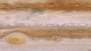 New movies of Jupiter are the first to catch an invisible wave shaking up one of the giant planet's jet streams, an interaction that also takes place in Earth's atmosphere and influences the weather.   For complete transcript, click  here .