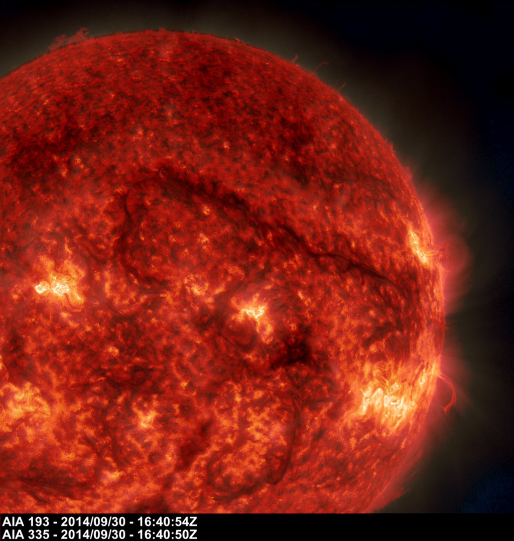 A dark snaking line in the upper right of this image on Sept. 30, 2014, shows a filament of solar material hovering above the sun's surface. NASA's SDO captured the image in extreme UV lightCredit: NASA/SDO