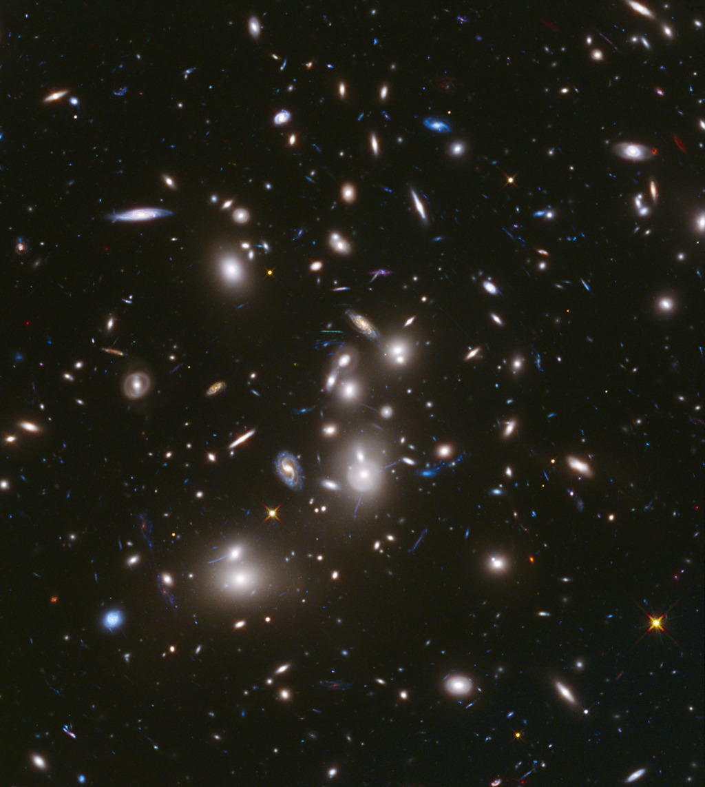 The galaxy cluster Abell 2744 is so massive that it distorts the space around it and produces an effect called gravitational lensing.
