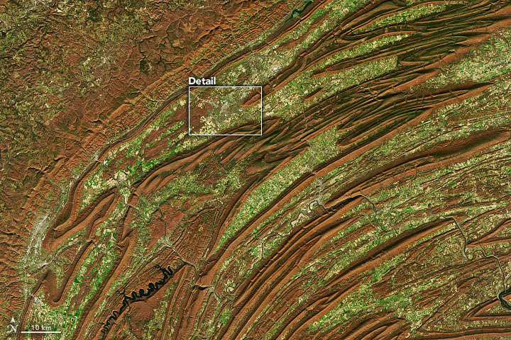 The folded mountains of central Pennsylvania were past peak leaf-peeping but still colorful when the Operational Land Imager (OLI) on the Landsat 8 satellite passed over on November 9, 2020. The natural-color images above show the hilly region around State College, Pennsylvania; the one below shows the same scene overlaid on a digital elevation model to highlight the topography of the area.
