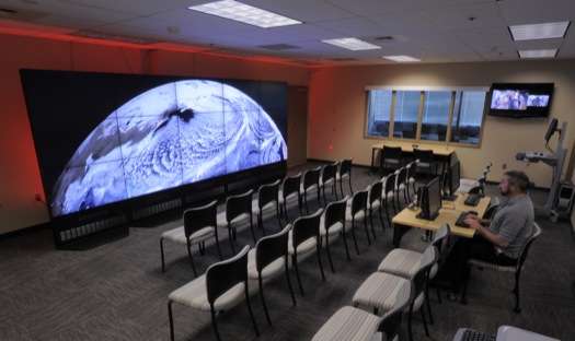 The NASA Center for Climate Simulation (NCCS) Data Exploration Theater features a 17- by 6-foot multi-screen visualization wall for engaging visitors and scientists with high-definition movies of simulation results. Here, the wall displays a 3.5-kilometer-resolution global simulation that captures numerous cloud types at groundbreaking fidelity.

Credit: NASA/Pat Izzo