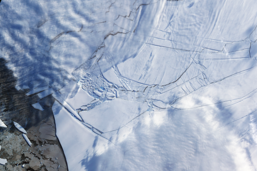 The Wilkins Ice Shelf, a thick slab of ice on the western side of the Antarctic Peninsula, underwent several breakups in 2008. The ice began to rapidly retreat in February, near the end of the Antarctic summer. In May, during the Antarctic autumn, another breakup occurred. Fresh cracks appeared on the shelf in late November 2008 and by the beginning of 2009, a narrow ice bridge was all that remained to connect the ice shelf to ice fragments fringing nearby Charcot Island. That bridge gave way in early April 2009. This image was taken days after the ice bridge rupture. Since ice reflects light from the sun, as polar ice caps melt, less sunlight gets reflected into space. It is instead absorbed by the ocean and land, increasing surface heat budgets and fueling further melting. 


Image taken on April 12, 2009 by the Advanced Spaceborne Thermal Emission and Reflection Radiometer (ASTER) on NASA's Terra satellite.
Credit: NASA/GSFC/METI/ERSDAC/JAROS, and U.S./Japan ASTER Science Team.