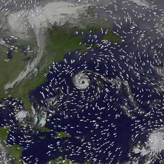 Hurricane Erin was positioned off the coast of the United States on September 10, 2001.  This animation shows the strength and direction of wind by animating small arrows.  Faster-moving arrows represent stronger winds.This product is available through our Web Map Service.