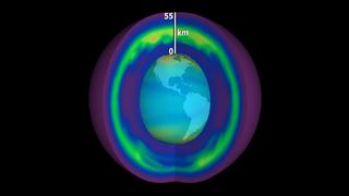 A section of the outer shell is removed to reveal the Earth. 