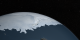 This animation shows the sea ice around Antarctica with a star background. 