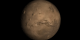 Print resolution image of Mars showing a partly shadowed Olympus Mons toward the upper left of the image.  The row of 3 volcanoes that form the base of a triangle in relationship to Olympus Mons are (from top to bottom): Ascraeus Mons, Pavonis Mons, and Arsia Mons.  Valles Marineris can also be seen.  It's the giant valley that slashes equatorially across the Martian landscape to the right of the volcanoes.