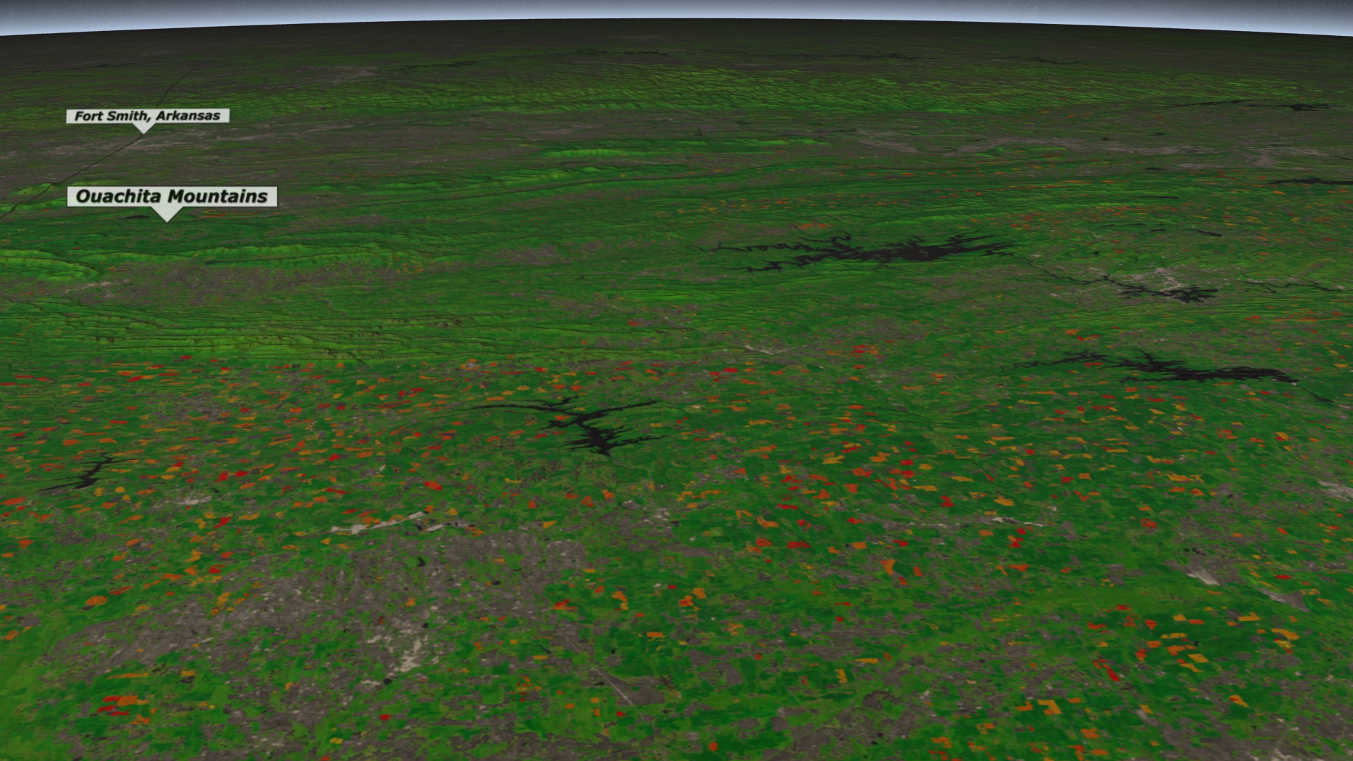 Animation that flys over the Ouachita Mountain range from east to west showing large areas of vegetation change south of the mountains (depicted in shades of orange and red).