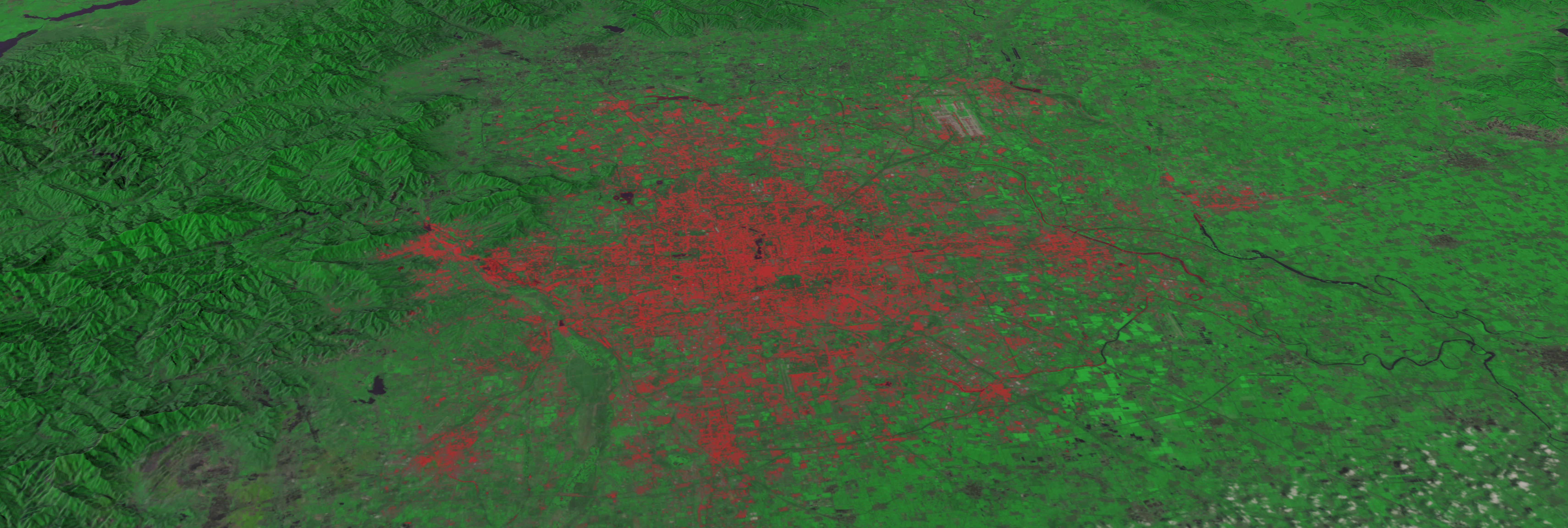 Animation zooming down to Beijing, China in 1978 via Landsat-3. The data then dissolves to Beijing in 2010 through the sensors of Landsat-5. The red areas are non-vegetated urban areas. 