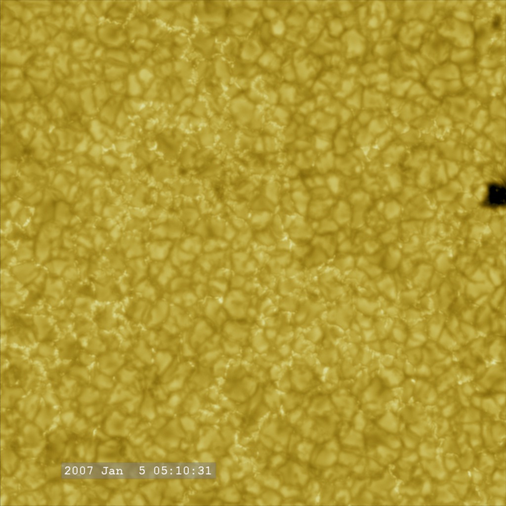 A closeup on solar convection cells with a small sunspot forming (on the right).