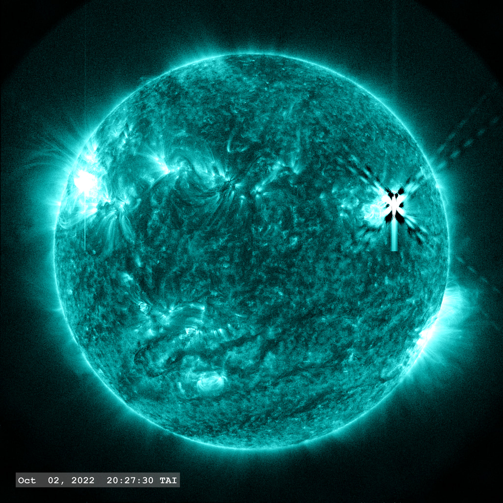 The solar flare as seen in AIA 131 Angstrom filter. Correction is applied for the instrument Point-Spread Function (PSF).  The dark area around the flare event is an artifact of the point-spread function correction process.