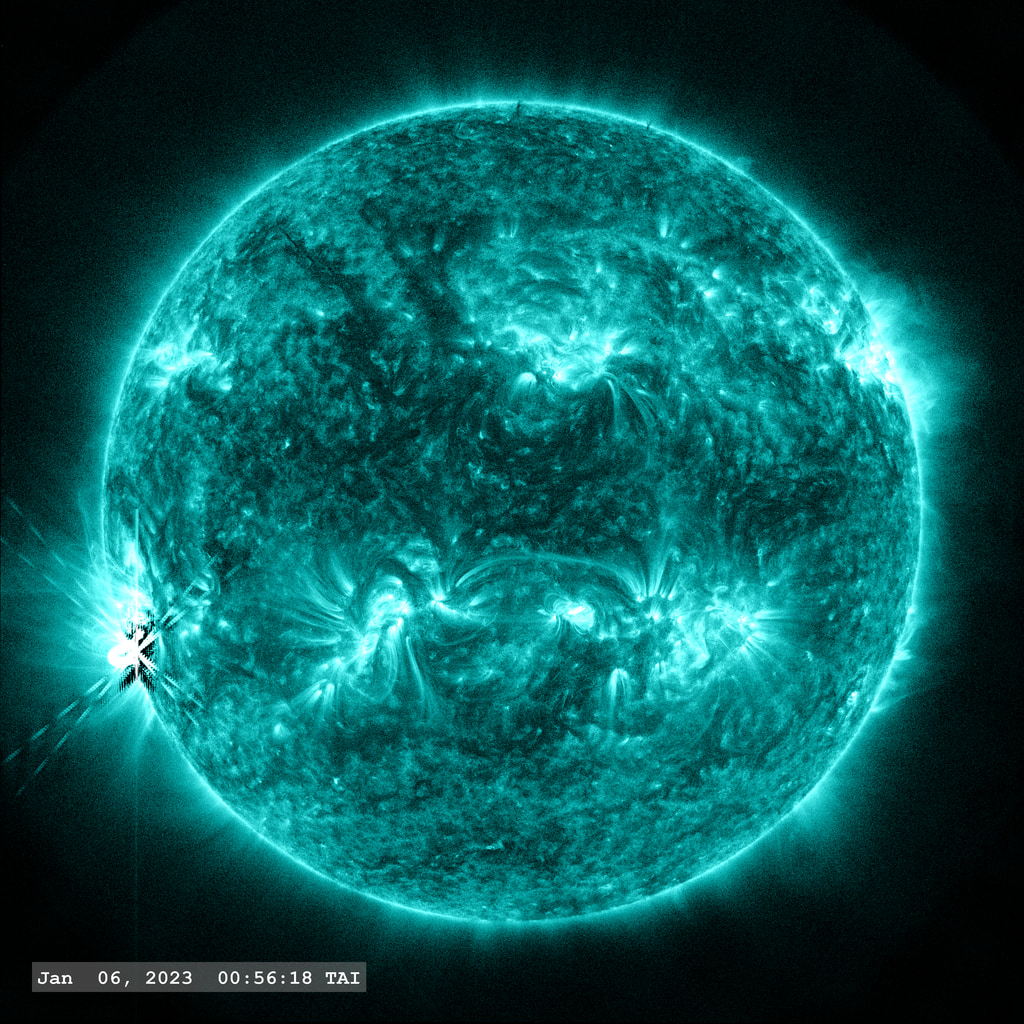 The X1.2 flare event of January 6, 2023 as seen in the SDO AIA 131 angstrom filter.  The dark region around the central 'X' marking the flare is an artifact of the PSF correction. 'Flickering' in the images around the flare are created due to the 'flare mode' images which have a shorter exposure. Normalizing the solar disk to the same brightness in these frames enhances the background noise off the solar disk.