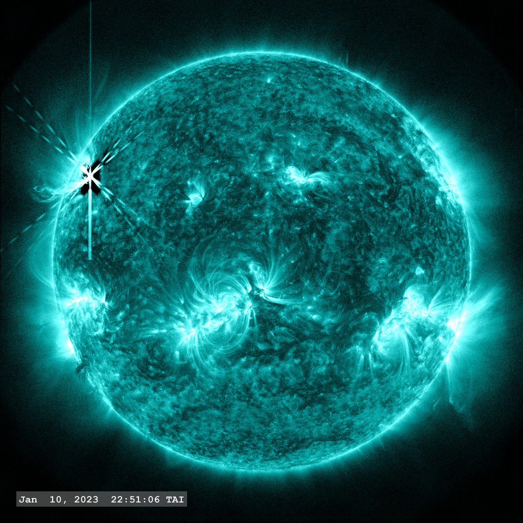 Active Region 13186 (upper left of solar disk) fires off an X-class flare (X1.0) in this view from SDO/AIA filter 131 angstroms.