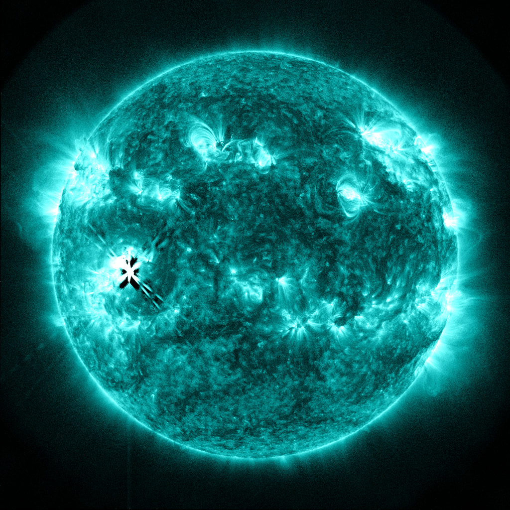Active Region 13217 (lower left of solar disk) fires off an X1.1  flare in this view from SDO/AIA filter 131 angstroms.