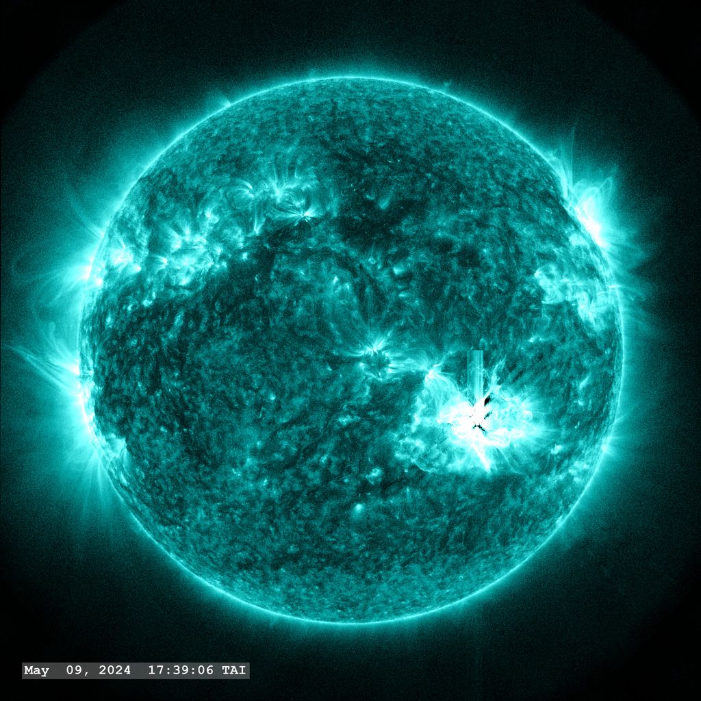 Active Region 13664 (in the lower right quadrant) launches yet another strong flare (X1.1) on May 9, along with a bright stream of plasma in this view through the SDO AIA 131 ångstrom filter.