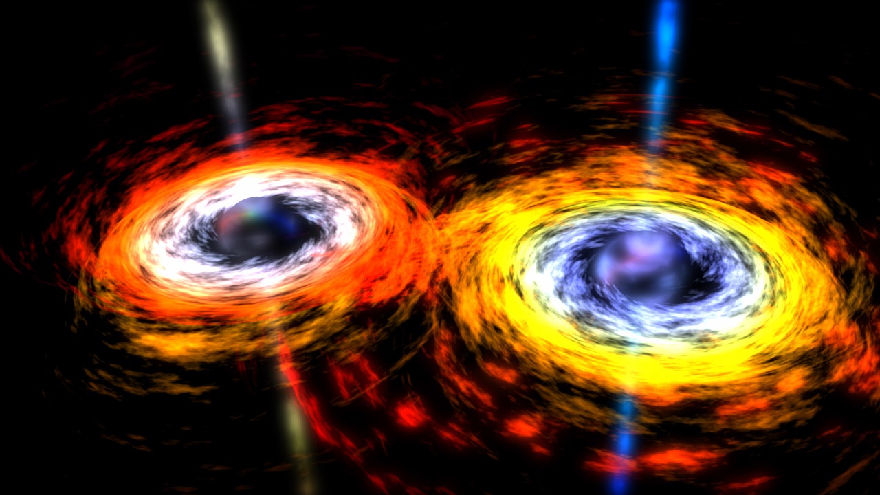 A closer look at the center of a spiral galaxy reveals a pair of black holes locked in a death spiral. When they merge, a massive amount of energy is released in the form of jets.