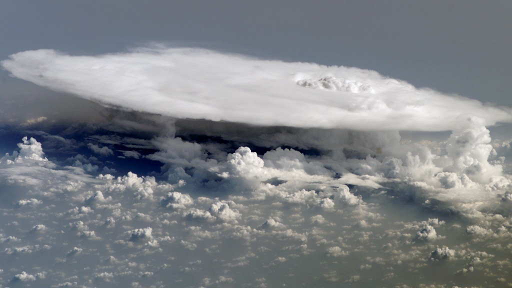 This photograph, taken from the International Space Station, shows a massive cumulus cloud over western Africa.