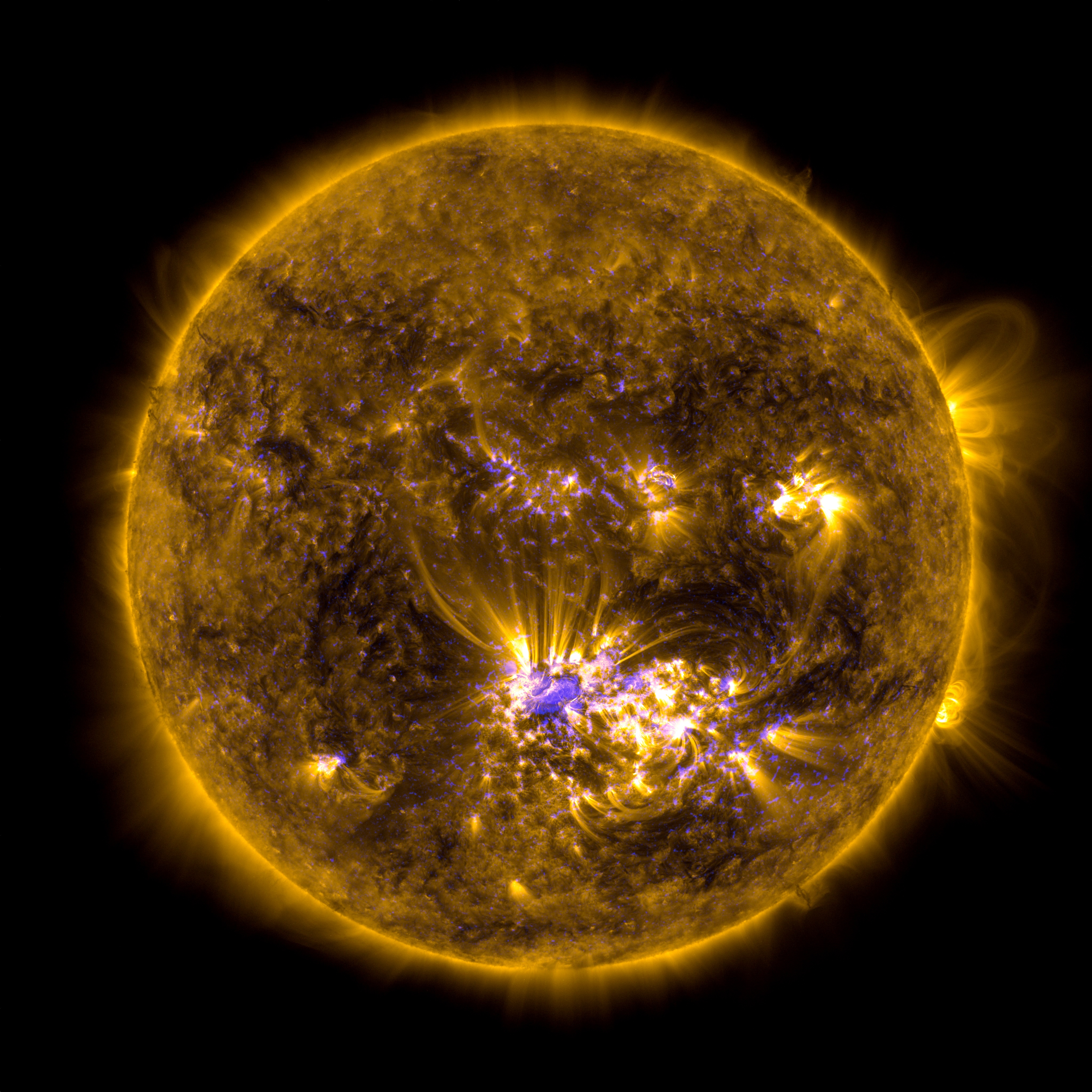 This image combines two sets of observations of the sun at 10:45 AM EDT, July 12, 2012 from the Solar Dynamics Observatory (SDO) to give an impression of what the sun looked like shortly before it unleashed an X-class flare beginning at 12:11 PM EDT.  The image incorporates light in the 171 angstrom wavelength, which shows off giant loops of solar material overlying the middle of the sun over Active Region 1520 where the flare originated.  The second set of observations is called a magnetogram, which highlights magnetic fields on the sun. Together these kinds of observations can help scientists understand the magnetic properties of the sun that lead to giant explosions like flares. 