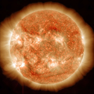 Visible in the lower left corner, the sun emitted an M6 solar flare on Nov. 13, 2012, which peaked at 9:04 p.m. EST. This image is a blend of two images captured by NASA's Solar Dynamics Observatory (SDO), one showing the sun in the 304 