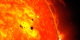 The bottom two black spots on the sun, known as sunspots, appeared quickly over the course of Feb. 19-20, 2013. These two sunspots are part of the same system and are over six Earths across. This image combines images from two instruments on NASA's Solar Dynamics Observatory (SDO): the Helioseismic and Magnetic Imager (HMI), which takes pictures in visible light that show sunspots and the Advanced Imaging Assembly (AIA), which took an image in the 304 angstrom wavelength showing the lower atmosphere of the sun, which is colorized in red.   Credit: NASA/SDO/AIA/HMI/Goddard Space Flight Center
