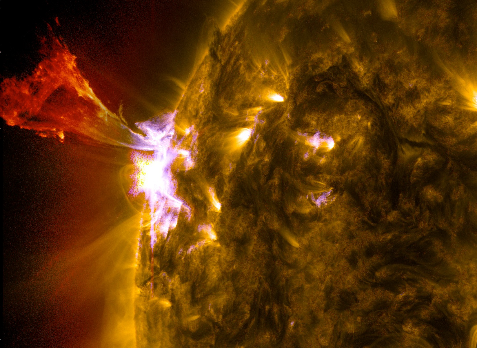 A burst of solar material leaps off the left side of the sun in what's known as a prominence eruption. This image combines three images from NASA's Solar Dynamics Observatory captured on May 3, 2013, at 1:45 pm EDT, just as an M-class solar flare from the same region was subsiding. The images include light from the 131-, 171- and 304-angstrom wavelengths.Credit: NASA/SDO/AIA