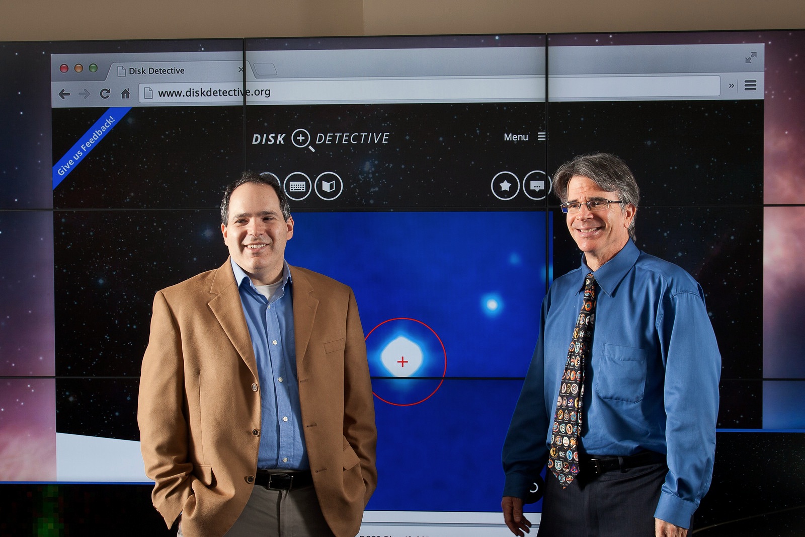 Marc Kuchner, the principal investigator for DiskDetective.org (left) and James Garvin, the chief scientist for NASA Goddard's Sciences and Exploration Directorate, discuss the crowdsourcing project in front of the hyperwall at Goddard's Science Visualization Lab. Credit: NASA's Goddard Space Flight Center/David Friedlander