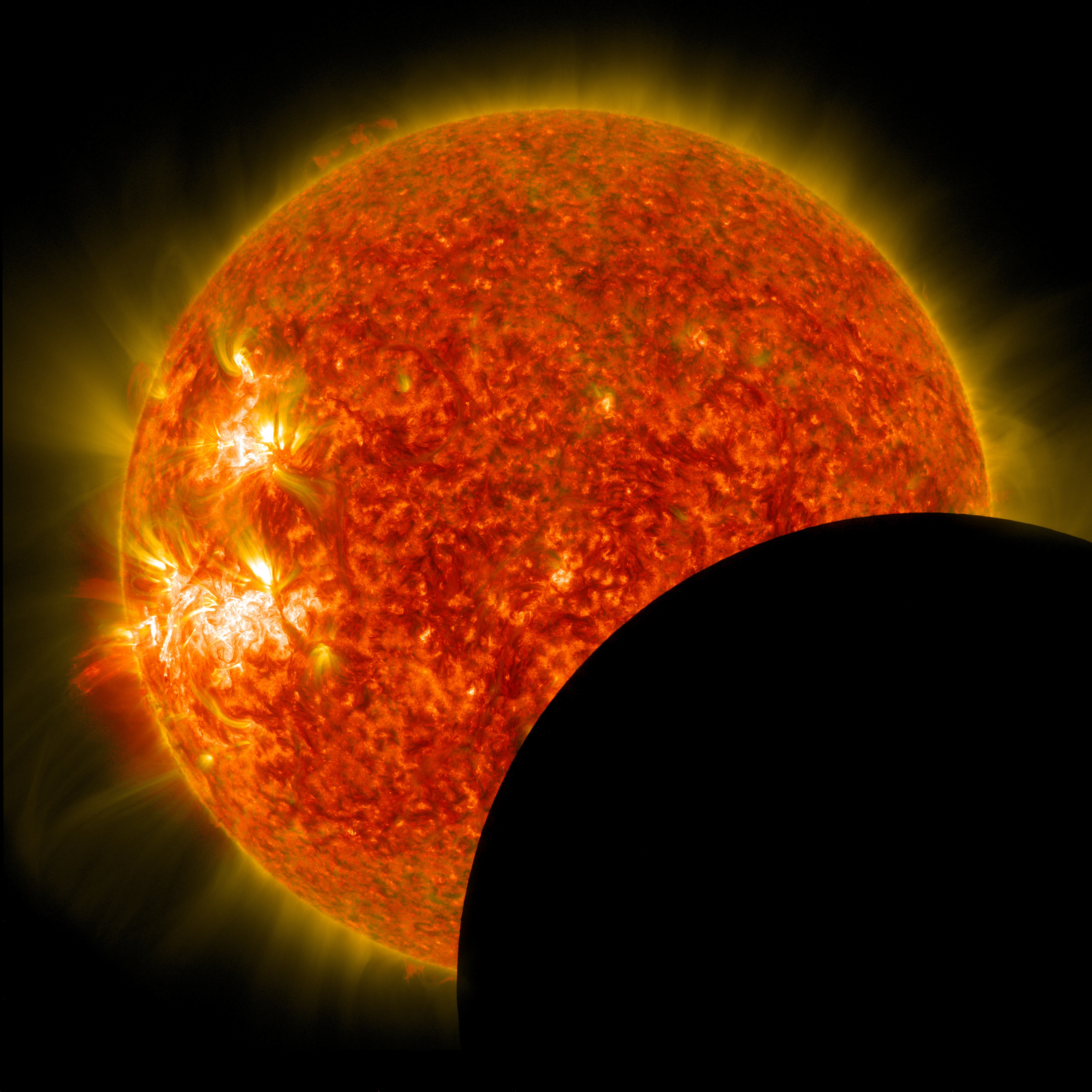 NASA's Solar Dynamics Observatory captured this image of the moon crossing in front of its view of the sun on Jan. 30, 2014, at 10:30 a.m. EST in 171 and 304 angstrom light. The two wavelengths are blended together. Credit: NASA/SDO