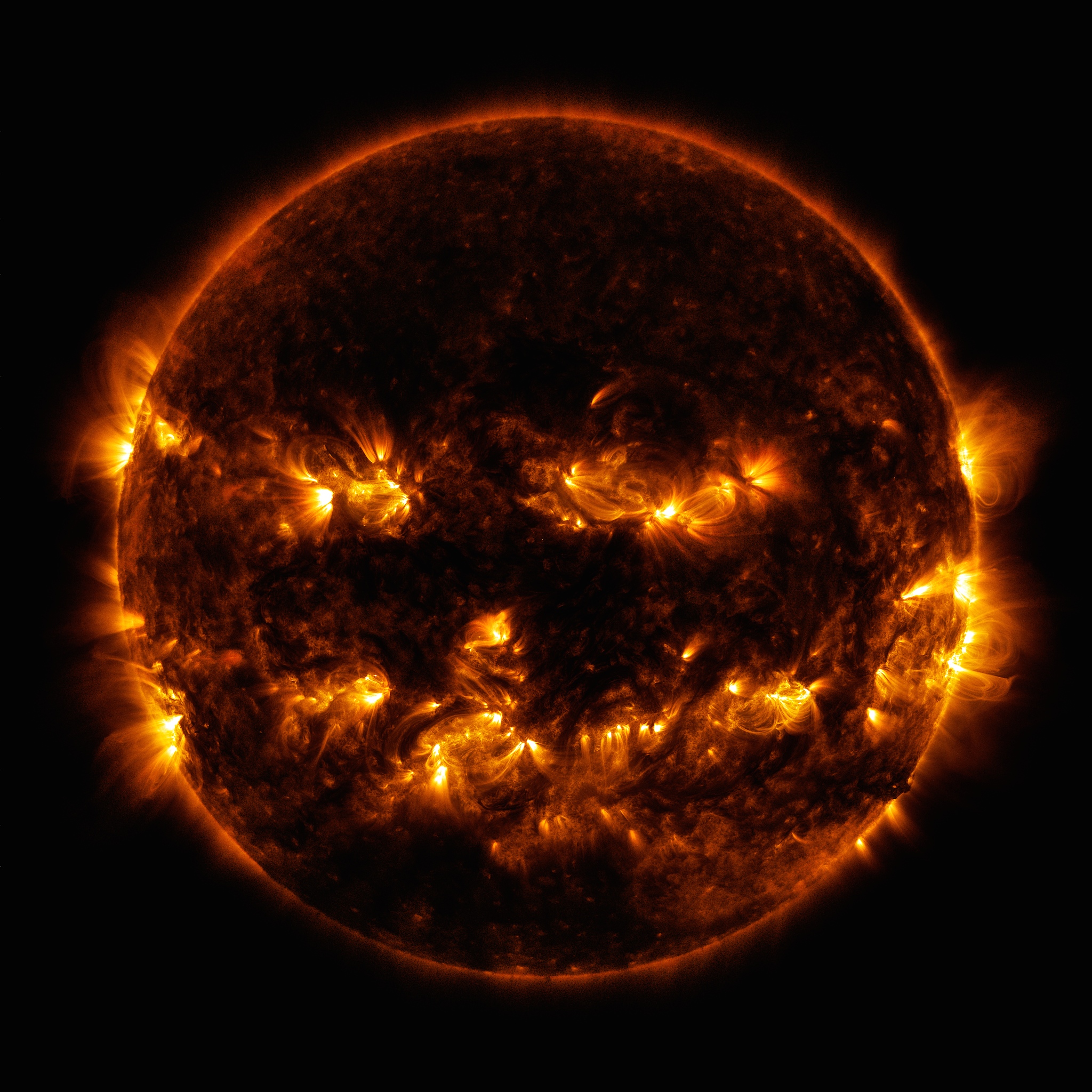On October 8, 2014, active regions on the sun gave it the appearance of a jack-o'-lantern.  This image is a blend of 171 and 193 angstrom light as captured by the Solar Dynamics Observatory.Credit: NASA/GSFC/SDO