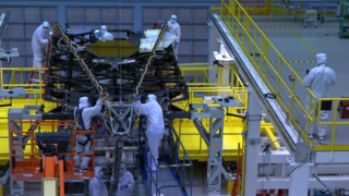 Engineers work in the NASA Goddard Space Flight Center’s cleanroom to stow the Webb Telescope’s Backplane Pathfinder and its Secondary Mirror Support Structure in preprartion for placing it into a large shipping container and transported to the NASA Johnson Space Center for cryogenic testing.