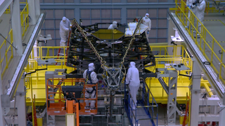Engineers work in the NASA Goddard Space Flight Center’s cleanroom to stow the Webb Telescope’s Backplane Pathfinder and its Secondary Mirror Support Structure in preprartion for placing it into a large shipping container and transported to the NASA Johnson Space Center for cryogenic testing.