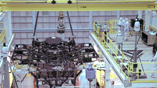 Produced Video showing engineers in the NASA Goddard Space Flight Center cleanroom placing the first mirror on the Webb Telescope.