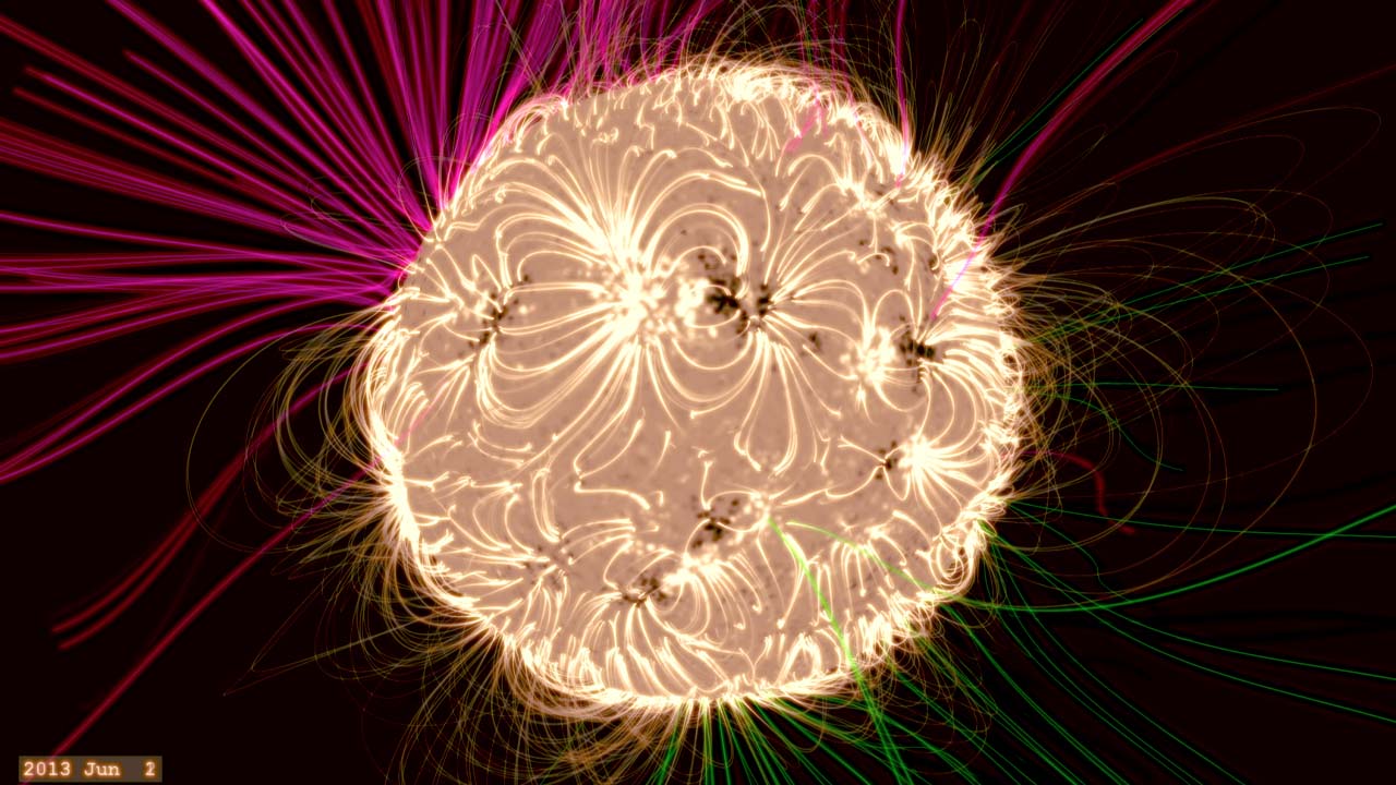 Holly Gilbert, NASA GSFC solar scientist, explains a model of magnetic fields on the sun.