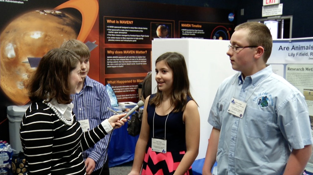 Michelle Handleman meets some of the participants of the GLOBE program's science fair. 