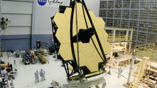 On May 4th 2016 engineers at the Goddard Space Flight Center tilted the uncovered primary mirror of the James Webb Space Telescope upright and to a rollover position.

In this rare timelapse video see inside the world's largest clean room at NASA's Goddard Space Flight Center in Greenbelt, Maryland as the James Webb Space Telescope team lifts and turns the telescope for the first time. With glimmering gold surfaces, the large primary and rounded secondary mirror on this telescope are specially designed to reflect infrared light from some of the first stars ever born. The team will now begin to prepare to install the telescope's science instruments to the back of the mirrors. Webb is an international project led by NASA with its partners, ESA (European Space Agency) and the Canadian Space Agency. For more information, visit: www.jwst.nasa.gov or www.nasa.gov/webb
