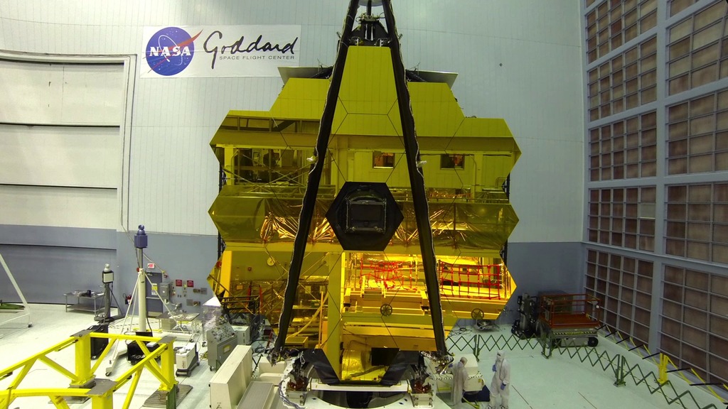 Time-lapse video showing NASA engineers moving the Webb telescope Optical Telescope and Integrated Science segment of the spacecraft from its assembly stand to the spacecraft rollover fixture and tilting the spacecraft vertically.  