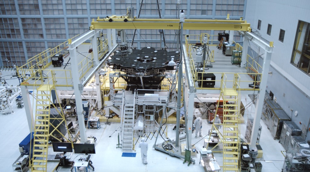 4K B-roll footage of the 18th golden mirror being installed to the backplane structure of the Webb Telescope.  