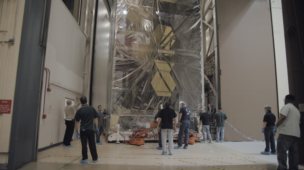 Engineers at NASA's Goddard Space Flight Center move the Webb telescope from the cleanroom to the acoustic chamber for testing.  Once these tests are complete, the telescope will be moved back to the cleanroom.  