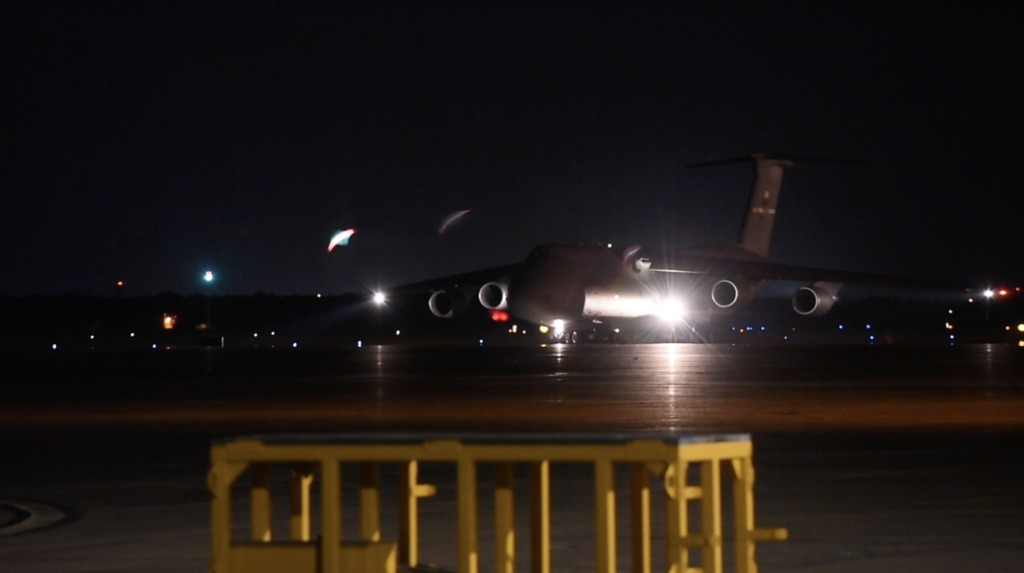 The U.S. Air Force C5M Super Galaxy transport aircraft arrives at Ellington Field Reserve Joint Base near Houston, TX.  The Webb Telescope inside its STTARS container and other equipment is unloaded from the aircraft.  
