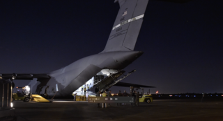 On May 5, 2017, the Webb Telescope team unloads the telescope from a C5M Super Galaxy aircraft at Ellington Field Reserve Base in Houston.