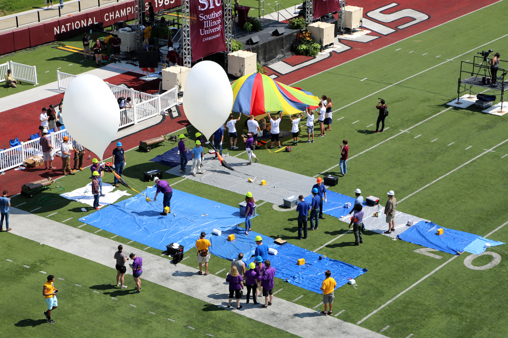 Carbondale, IL - The Eclipse Ballooning Project inflating high altitude balloons in Saluki Stadium during the Aug. 21, 2017, total solar eclipse. Credit: NASA/Joy Ng