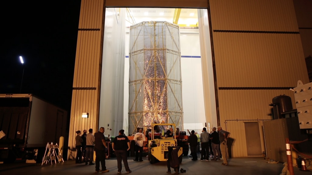 B-Roll footage of engineers at Northrop Grumman in Los Angeles California, moving the James Webb Space Telescope's Spacecraft Element into the acoustic testing facility for testing.